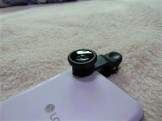 Screw a lens to this clip. Place it over your phone lens.
